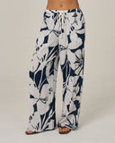 Salty Crew Womens Graphic Bloom Pant in Dark Navy blue close up view highlighting the premium soft cotton weave fabric texture crisp graphic print borders and stitched brand clamp label, sold by Point Break Cambridge local family surf shop at 63 Duke street.
