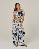 Salty Crew Womens Graphic Bloom Pant in Dark Navy blue front view showing the comfortable relaxed loungewear pants silhouette flexible elastic waistband functional drawcords and vibrant floral graphic screen print, sold by Point Break Cambridge local family surf shop at 63 Duke street.