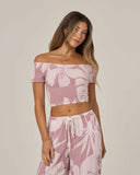 Salty Crew Womens Graphic Bloom Top in Faded Mauve pastel purple front view showing the comfortable relaxed short sleeve casual top silhouette protective clean neckline lines and vibrant floral graphic screen print, sold by Point Break Cambridge local family surf shop at 63 Duke street.