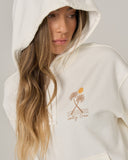 Salty Crew Womens Moon Wake Hoodie in Off White cream close up view highlighting the premium soft cotton weave vintage washed fleece texture kangaroo pocket borders and stitched brand clamp label, sold by Point Break Cambridge local family surf shop at 63 Duke street.