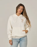 Salty Crew Womens Moon Wake Hoodie in Off White cream front view showing the comfortable oversized pullover silhouette protective attached hood lines and clean graphic chest screen print, sold by Point Break Cambridge local family surf shop at 63 Duke street.