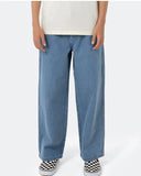 Person wearing light blue jeans and checkered shoes on a white background Front view of the Santa Cruz Yelling Stack Baggy Denim Jeans in Mid Blue, showcasing the loose wide-leg silhouette and pocket layout.
