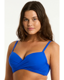 Woman wearing a blue bikini top against a white background Detailed close-up macro view of the premium recycled eco fabric texture and seamless crossover stitching on the Cobalt Sea Level swimsuit bra.