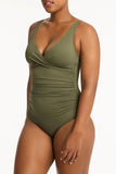 Green swimsuit worn by a model on a white background