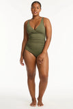 Woman wearing a green swimsuit on a white background 
