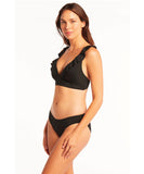 This image features the Sea Level Essentials Regular Bikini Pant in black, modeled by a woman with a confident posture. The swimwear is designed with a seamless, comfortable fit, highlighted by its smooth, bagged out edges and powermesh support.  Side profile view of the Sea Level Essentials Regular Bikini Pant in Black, highlighting the comfortable hip width and seamless leg line.