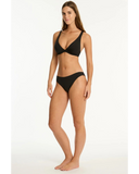 Woman wearing a black bikini on a white background. Side profile angle of the Black Sea Level Essentials Cheeky Bikini Pant, highlighting the leg cut-out and comfortable hip bands.