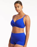 A woman modeling a bright royal blue two-piece swimsuit with a wrap-style bra top and matching high-waisted shorts against a plain white studio background. Side profile view of the Cobalt Sea Level Essentials DD/E Cup Bikini Top, highlighting the supportive side boning and comfortable bands.