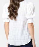Back view of the women's Seeking Lola Carefree Butterfly blouse displaying the comfortable relaxed fit and clean shoulder drape.