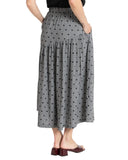 Seeking Lola Devine Maxi Skirt in Black Heart print side profile view highlighting the fluid movement and elegant side seam tailoring, sold by Point Break Cambridge local family surf shop at 63 Duke street.