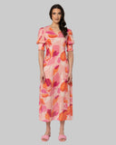 Seeking Lola Florence Dress in Strawberry Punch front view showing the elegant relaxed midi length silhouette flattering tailored V-neckline and clean casual flowing lower pink hemline profile, sold by Point Break Cambridge local family surf shop at 63 Duke street.