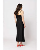 Seeking Lola Viva Skirt in Black back view showing the elegant relaxed drape premium dark fabric alignment and clean structural hip paneled tailoring with flatlock seam stitching, sold by Point Break Cambridge local family surf shop at 63 Duke street.