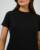 Close up detail of the premium soft black cotton jersey fabric weave, ribbed neckline stitching, and Silent Theory internal branding.