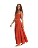Sisstrevolution Makena Woven Skirt in Cayenne red side profile view highlighting the fluid active movement and elegant low-profile side seam construction, sold by Point Break Cambridge local family surf shop at 63 Duke street.