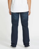 Back view of the Volcom Solver Modern Fit Denim Jeans in Vintage Blue wash showcasing the signature asymmetric yoke and stone embroidery on the pocket.