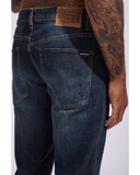 Back view of the Volcom Solver Modern Fit Denim Jeans in New Vintage Blue wash showcasing the signature asymmetric yoke and stone embroidery on the pocket.