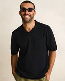 Model wearing the Rhythm Textured Knit Whip Stitch Polo - Black on a plain background