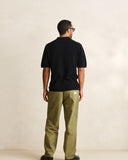 Model wearing the Rhythm Textured Knit Whip Stitch Polo - Black on a plain background