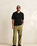 Model wearing the Rhythm Textured Knit Whip Stitch Polo - Black on a plain background