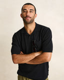 Model wearing the Rhythm Textured Knit Whip Stitch Polo - Black on a plain background