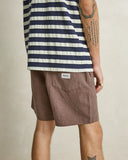Model wearing the Rhythm Textured Linen Jam Short - Chocolate on a plain background