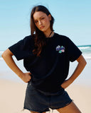  The Mad Hueys Anchor Ladybug Womens SS Tee in Black front view showing the comfortable crew neckline and custom anchor ladybug chest graphic, sold by Point Break Cambridge local family surf shop at 63 Duke street.