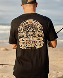 The Mad Hueys Dragon Captain SS Tee in Black close up view highlighting the premium soft cotton knit fabric weave texture and high density screen print graphic finish detail, sold by Point Break Cambridge local family surf shop at 63 Duke street.