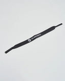 The Mad Hueys Hueys Sun Strap in Black front view showing the screen printed brand logo on the flat neoprene retainer strap, sold by Point Break Cambridge local family surf shop at 63 Duke street.