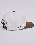 The Mad Hueys New Hueys Twill Snapback in White back view showing the premium panel construction and adjustable plastic snap back closure, sold by Point Break Cambridge local family surf shop at 63 Duke street.