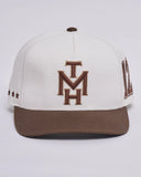 The Mad Hueys New Hueys Twill Snapback in White front view showing the structured crown flat brim and custom embroidered front graphic, sold by Point Break Cambridge local family surf shop at 63 Duke street.