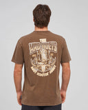 The Mad Hueys Scootin Shoey SS Tee in Walnut Washed brown back view showing the relaxed straight silhouette and bold oversized custom shoey graphic artwork print, sold by Point Break Cambridge local family surf shop at 63 Duke street.