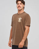 The Mad Hueys Scootin Shoey SS Tee in Walnut Washed brown front view showing the comfortable ribbed crew neck and signature chest brand graphic logo print, sold by Point Break Cambridge local family surf shop at 63 Duke street.
