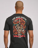 The Mad Hueys Shield Fk Off SS Tee in Vintage Black back view showing the relaxed straight silhouette and bold oversized custom shield brand artwork graphic print, sold by Point Break Cambridge local family surf shop at 63 Duke street.