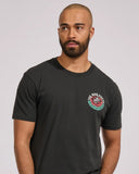 The Mad Hueys Shield Fk Off SS Tee in Vintage Black front view showing the comfortable ribbed crew neck and signature chest brand graphic logo print, sold by Point Break Cambridge local family surf shop at 63 Duke street.