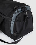 Unit Trail Duffle Bag side profile view highlighting the extra side zippered utility pockets and durable shoulder strap attachment anchorage points, sold by Point Break Cambridge local family surf shop at 63 Duke street.
