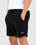 Unit Mens Boulevard Track Shorts in Black side profile view showing the casual relaxed fit outseam length cut and functional deep side hand pocket entry lines, sold by Point Break Cambridge local family surf shop at 63 Duke street.