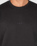 Unit Unisex Central Crew in Washed Black close up view highlighting the premium soft cotton fleece fabric weave internal brushed lining texture and high density screen print graphic detail, sold by Point Break Cambridge local family surf shop at 63 Duke street.