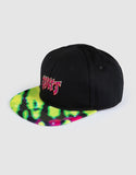 Unit Youth Trance Flat Peak Snapback Hat in Black front view showing the structured six panel crown flat brim and custom embroidered front brand logo graphic, sold by Point Break Cambridge local family surf shop at 63 Duke street.
