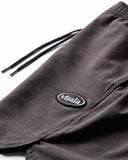 Vissla Solid Sets 17.5 Ecolastic Short in Black close up view highlighting the premium recycled stretch coconut fabric texture and durable drawcord tips, sold by Point Break Cambridge local family surf shop at 63 Duke street.