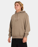 Man wearing a beige hoodie with text on a white background