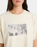 Beige t-shirt with a graphic design on a plain background