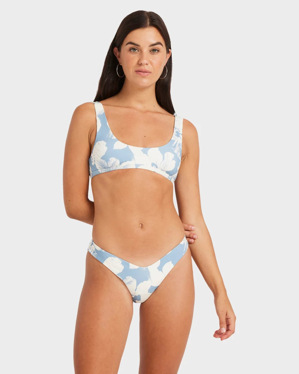 Woman wearing a blue and white cloud-patterned bikini on a light gray background Volcom Make Us Shine Tank Bikini Top - Bay Blue