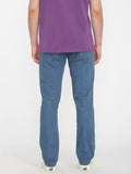 Back view of the Volcom Vorta Denim Slim Fit Jeans in Aged Indigo showcasing the signature asymmetric yoke and embroidered rear pockets.