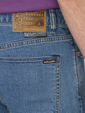 Close up detail of the premium aged indigo denim wash, metal pocket rivets, and Volcom branded hardware.