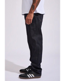 Side profile of the Volcom Vorta Denim Slim Fit Jeans in Rinse wash detailing the slim drape and dark outseam stitching.