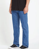 Side profile of the Volcom Solver Modern Fit Denim Jeans in BDL wash detailing the modern straight fit drape down to the hem.