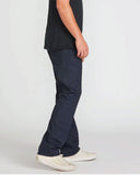Side profile of the Volcom Solver Modern Fit Denim Jeans in Indigo Wash detailing the modern straight fit drape down to the hem.