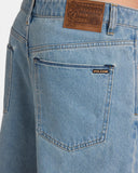 Volcom Chillow Denim Short in Stone Blue close up view highlighting the stone washed heavyweight cotton denim fabric texture metallic button fly and internal lining tags, sold by Point Break Cambridge local family surf shop at 63 Duke street.