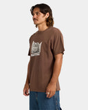 Text: Volcom Cocktail LSE Mens Short Sleeve T-Shirt in Brown Stone side profile view showcasing the relaxed loose fit silhouette comfortable short sleeves substantial 200gsm cotton jersey fabric and versatile earthy brown streetwear styling, sold by Point Break Cambridge local family surf shop at 63 Duke Street.