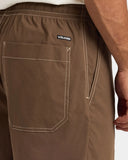 Volcom Mens Disturb Short 21 in Brown Stone close up view highlighting the lightweight quick-drying nylon fabric texture, adjustable waistband drawcord, printed mesh pocket lining, quality stitching and signature Volcom Stone star graphic detailing, sold by Point Break Cambridge local family surf shop at 63 Duke Street.